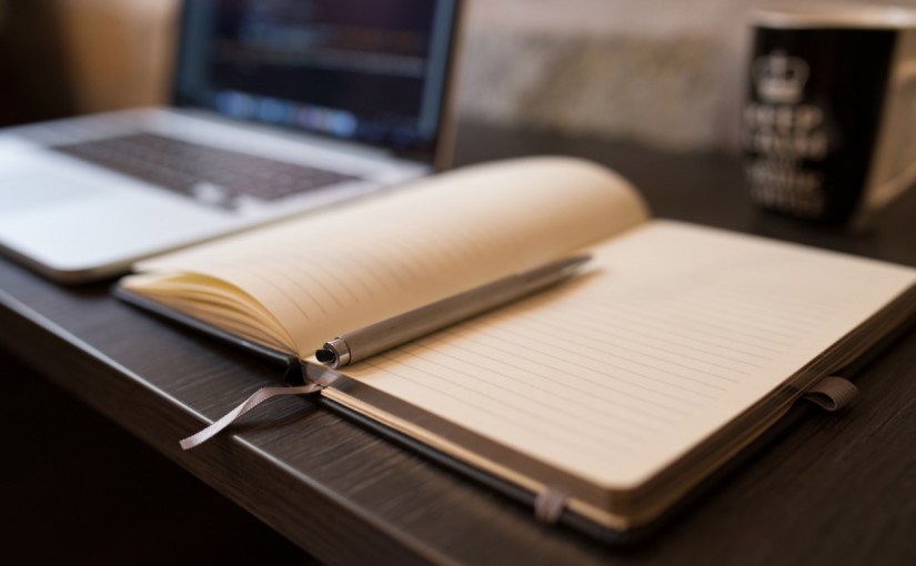 Image of notebook, pen, and laptop